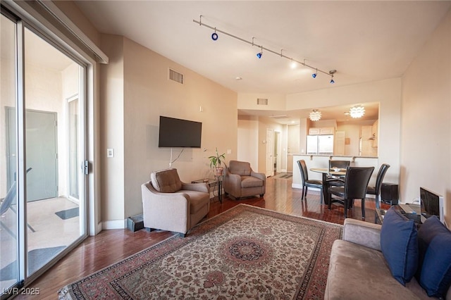 living room with track lighting and hardwood / wood-style flooring