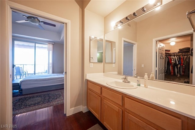 bathroom featuring ceiling fan, vanity, and wood-type flooring