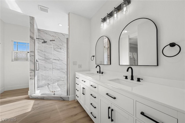 bathroom featuring vanity, a shower with shower door, and hardwood / wood-style floors