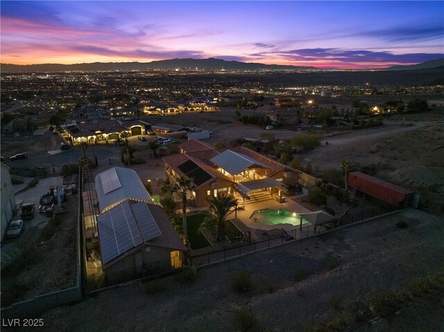 aerial view at dusk featuring a mountain view