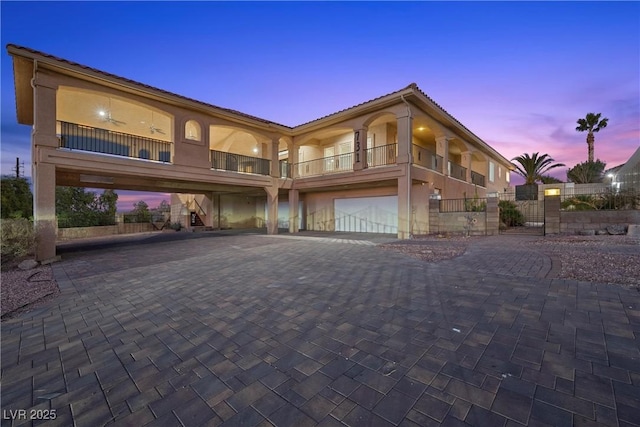 view of front of property with a garage and a balcony