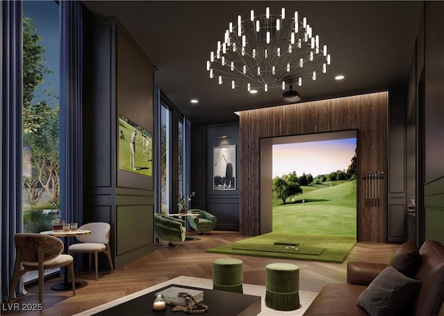 interior space with an inviting chandelier, golf simulator, and parquet flooring