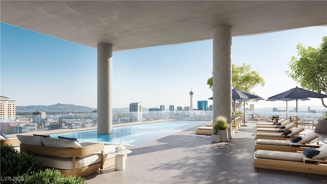 view of swimming pool with a patio area and a mountain view