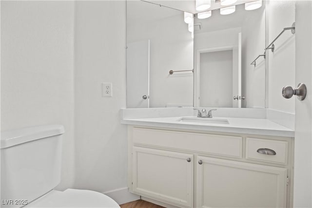 bathroom with toilet and vanity