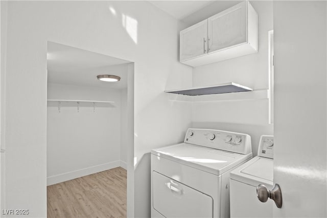 laundry room featuring washer and dryer and light wood-type flooring