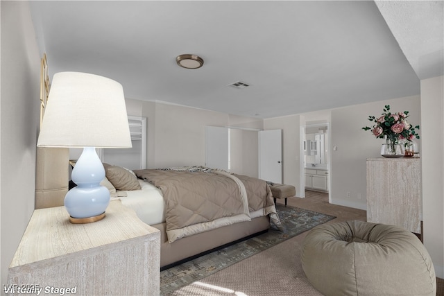 carpeted bedroom featuring connected bathroom