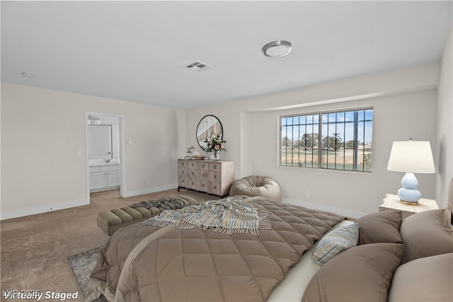 carpeted bedroom with ensuite bath