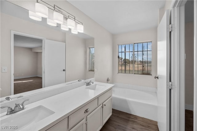 bathroom with vanity, a bathtub, and hardwood / wood-style floors