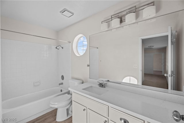 full bathroom with toilet, bathing tub / shower combination, hardwood / wood-style floors, and vanity