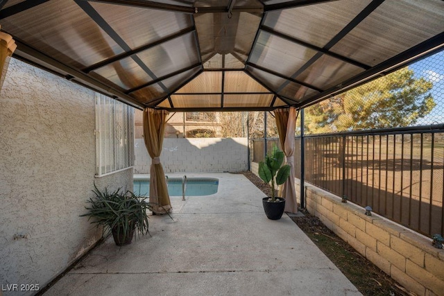 view of patio / terrace featuring a gazebo and a fenced in pool