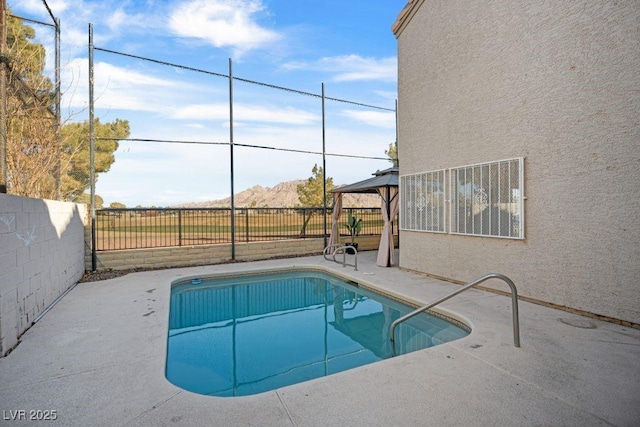 view of swimming pool featuring a gazebo, a mountain view, and a patio