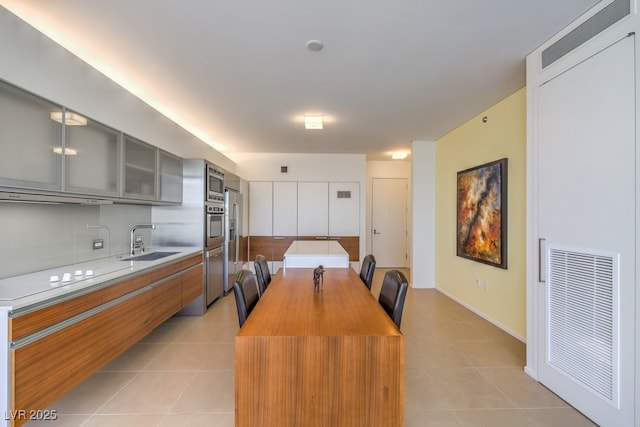 tiled dining area featuring sink