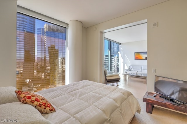 tiled bedroom with expansive windows