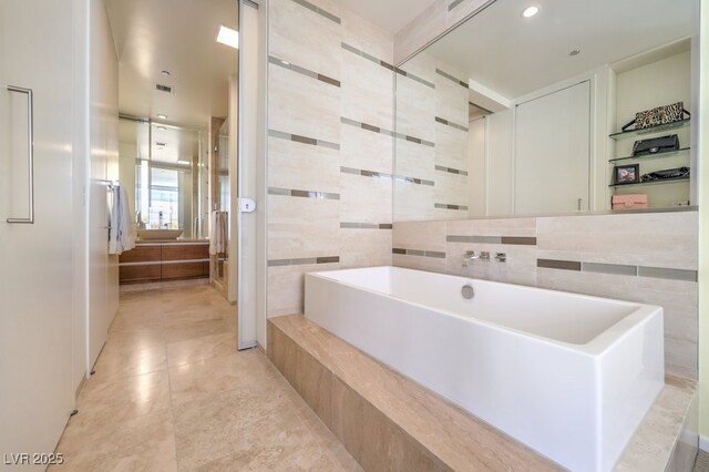 bathroom featuring a shower and tile walls