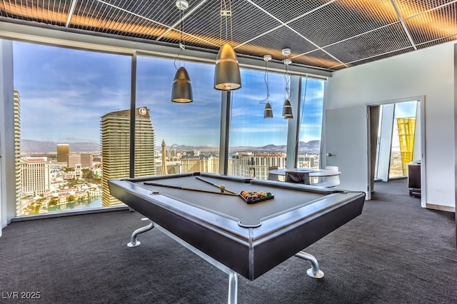 recreation room featuring dark carpet, billiards, and a wealth of natural light