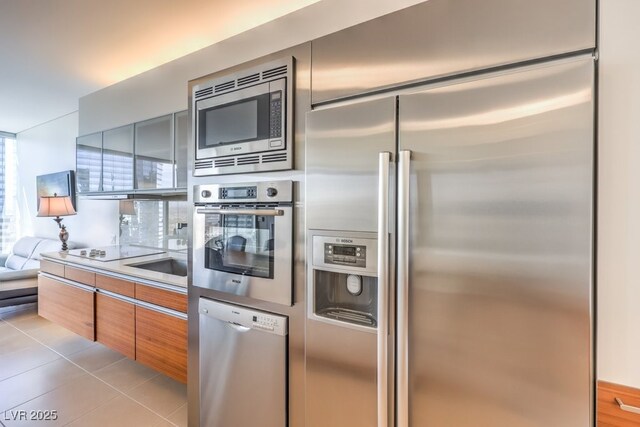 kitchen featuring light tile patterned floors and built in appliances