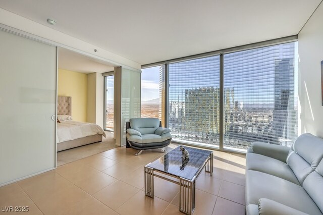 living room featuring light tile patterned flooring and floor to ceiling windows