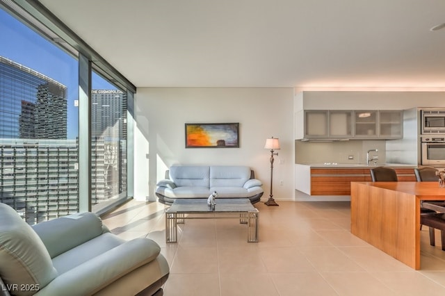 living room with expansive windows and light tile patterned floors