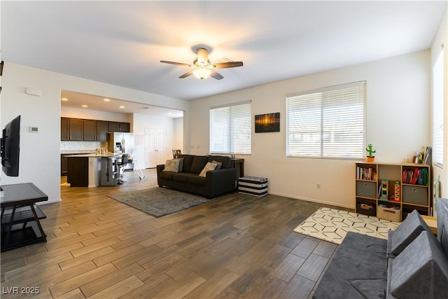 living room featuring ceiling fan and hardwood / wood-style floors