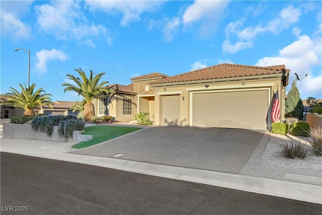 mediterranean / spanish home with a garage