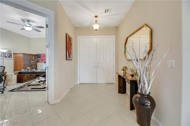 tiled foyer featuring ceiling fan