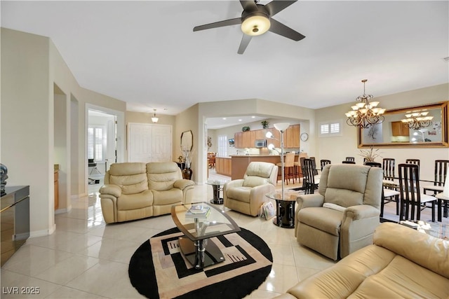 living room featuring light tile patterned floors and ceiling fan with notable chandelier