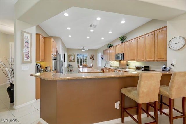 kitchen with ceiling fan, kitchen peninsula, and stainless steel appliances