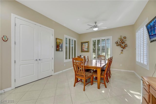 tiled dining space featuring ceiling fan