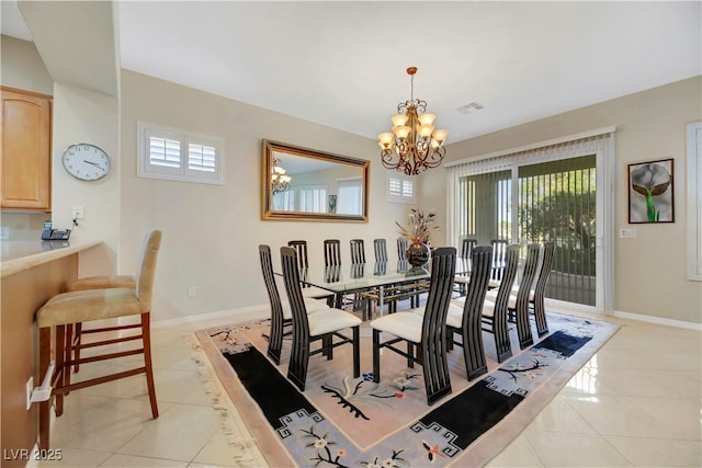 tiled dining space featuring a chandelier and a healthy amount of sunlight