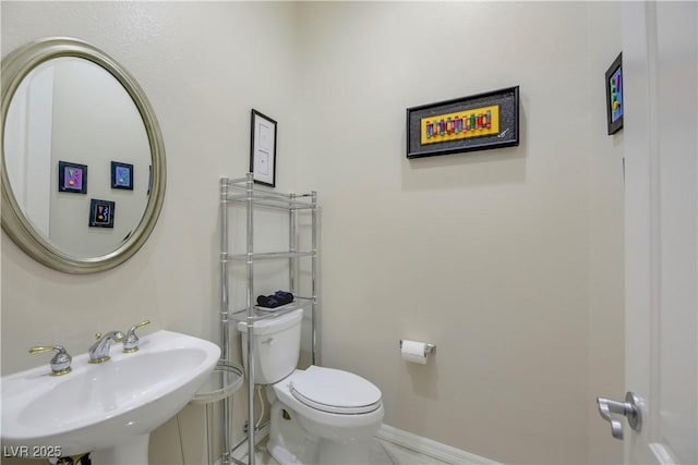 bathroom featuring toilet and sink