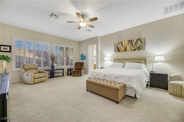 carpeted bedroom with ceiling fan and connected bathroom