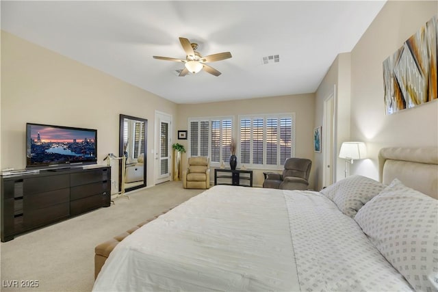 bedroom with ceiling fan and light colored carpet