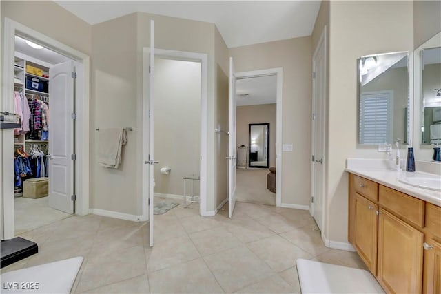 bathroom featuring toilet, vanity, and tile patterned floors