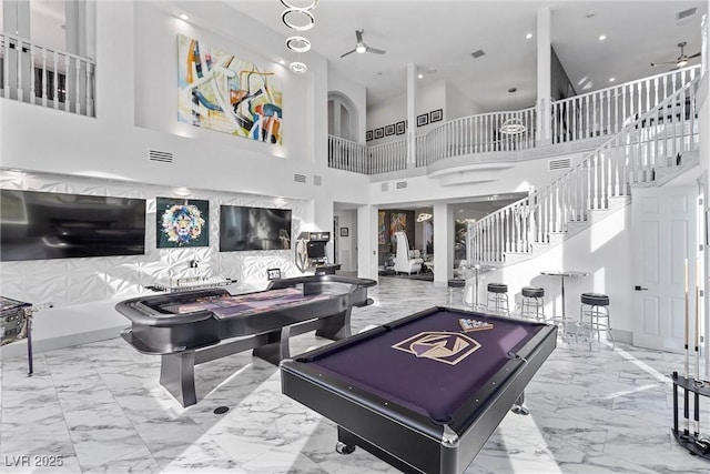 playroom featuring pool table, ceiling fan, and a high ceiling