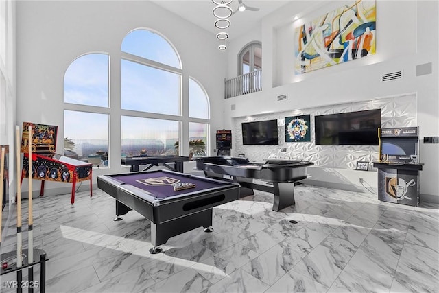 playroom with pool table and a high ceiling