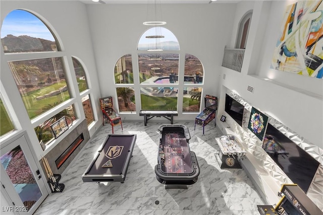 living room featuring a towering ceiling and a wealth of natural light