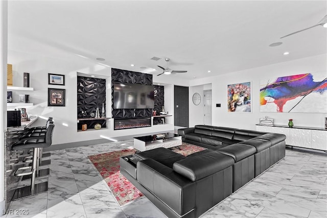 living room featuring a fireplace and ceiling fan