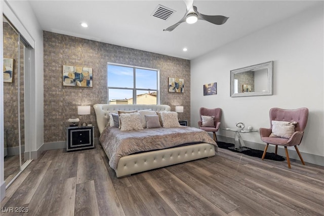 bedroom with wood-type flooring and ceiling fan