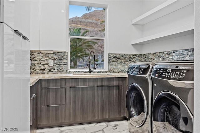 washroom with washer and clothes dryer and sink