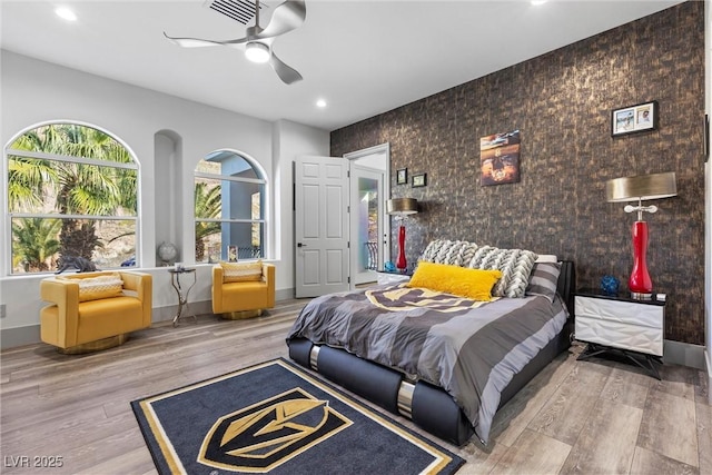 bedroom featuring wood-type flooring and ceiling fan