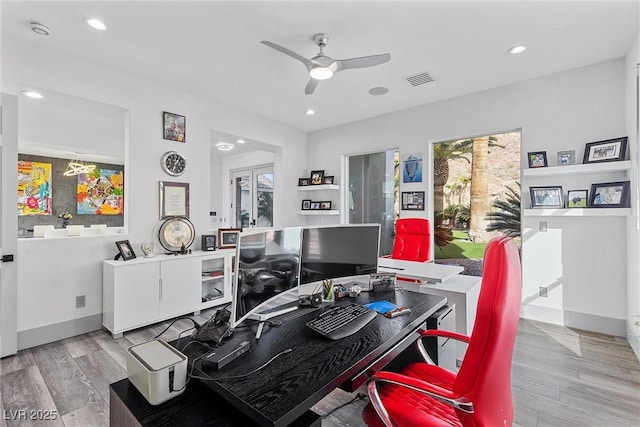 home office with ceiling fan and light wood-type flooring