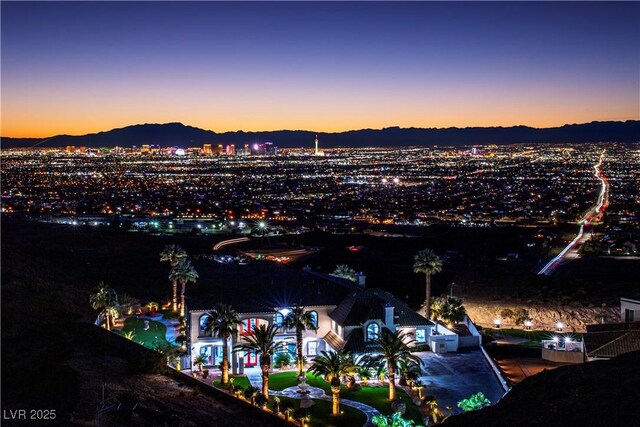 aerial view at dusk featuring a mountain view