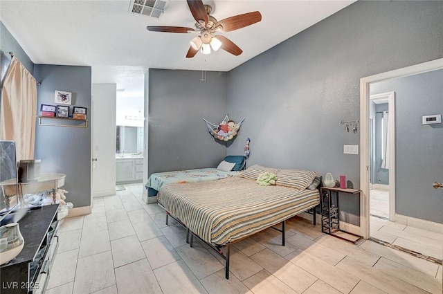 bedroom featuring ceiling fan and ensuite bathroom