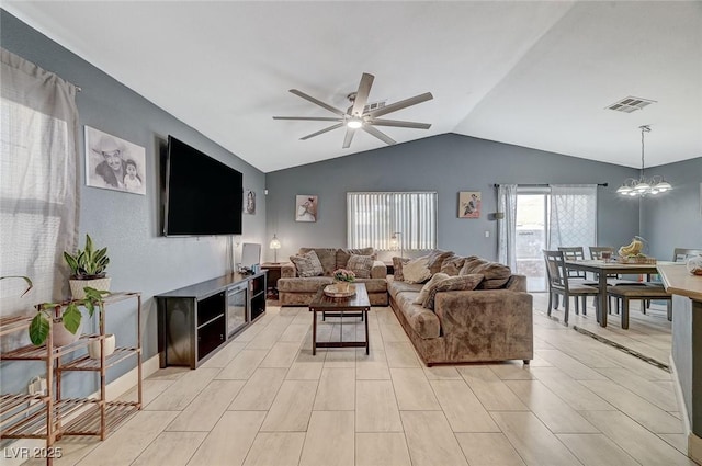 living room featuring lofted ceiling and ceiling fan with notable chandelier