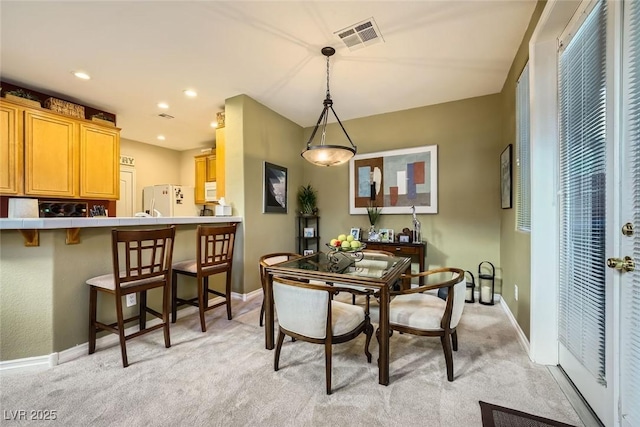 dining space featuring light colored carpet