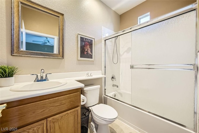 full bathroom with toilet, shower / bath combination with glass door, and vanity