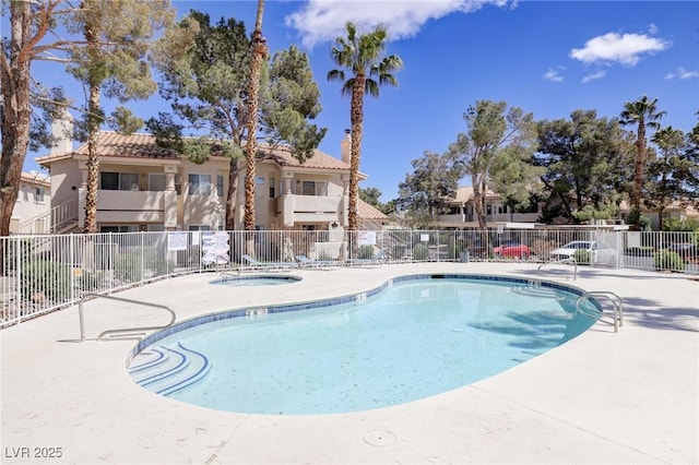 view of swimming pool with a patio area and a hot tub