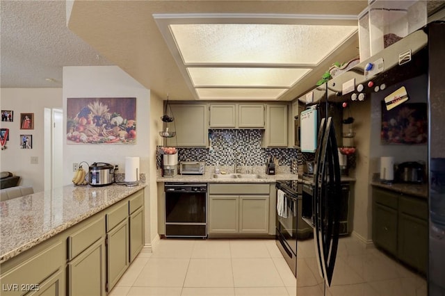 kitchen featuring black appliances, decorative backsplash, sink, light stone counters, and light tile patterned floors