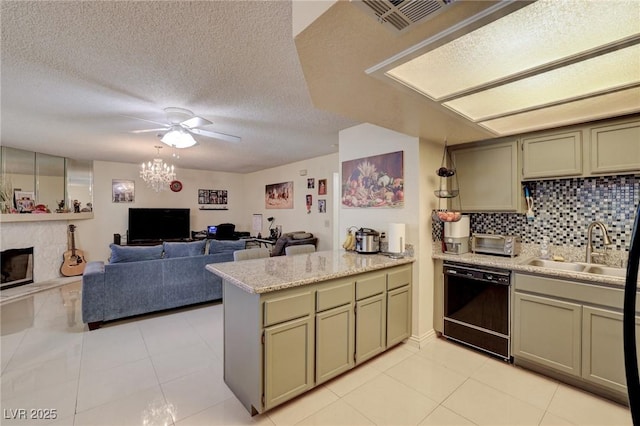 kitchen with a fireplace, dishwasher, kitchen peninsula, decorative backsplash, and light tile patterned floors