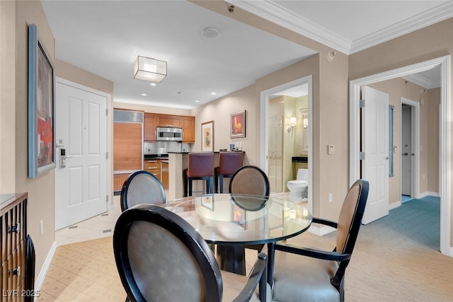 carpeted dining room featuring ornamental molding